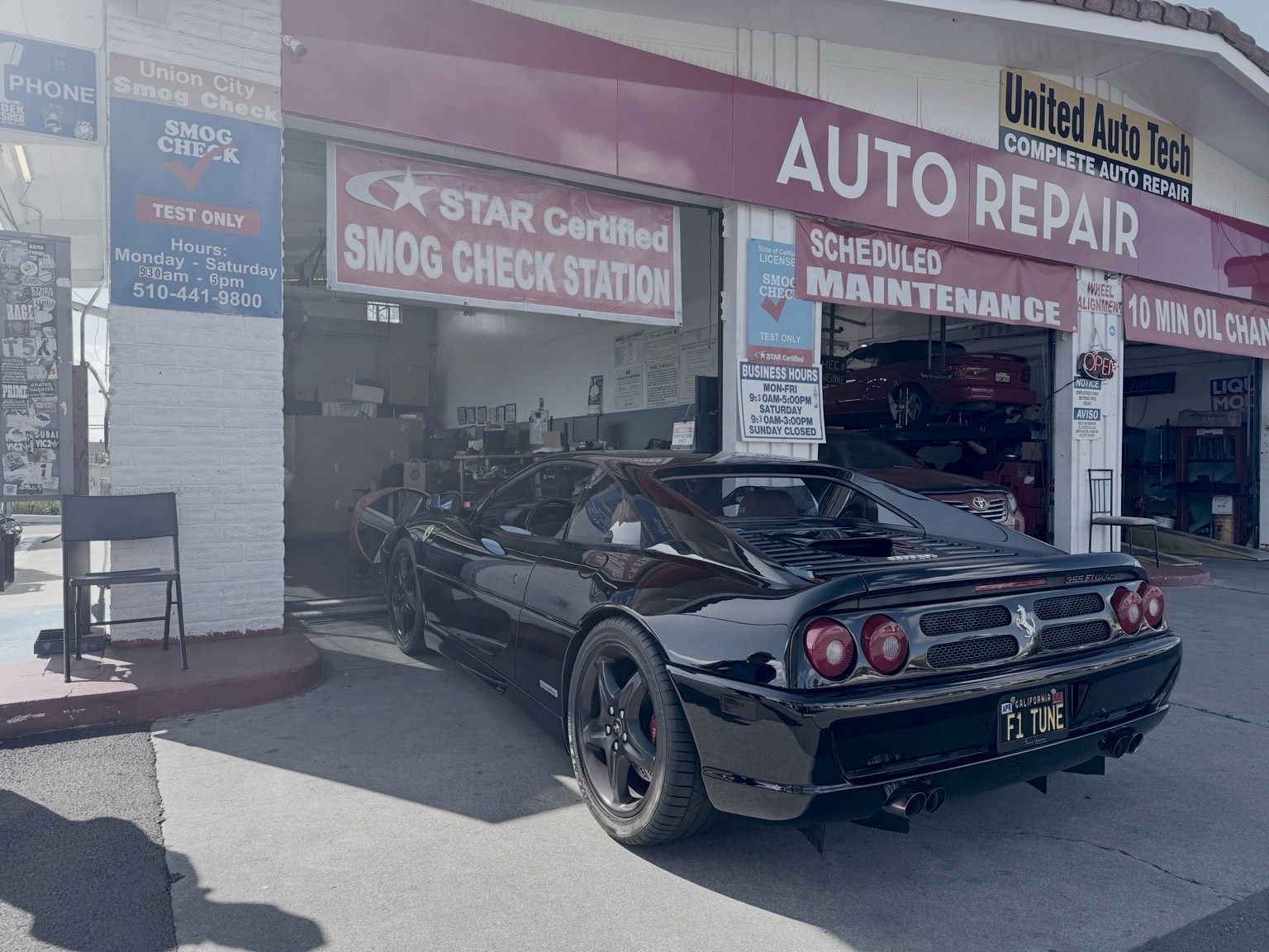 Black Ferrari F355 outside Union City Smog Check, under the STAR Certified Smog Check Station banner