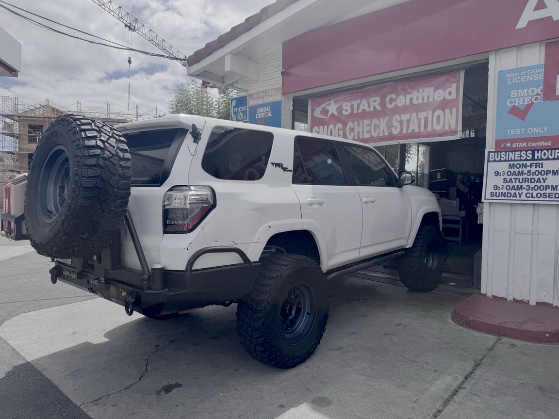 White Toyota 4Runner pulling into the Union City Smog Check test bay