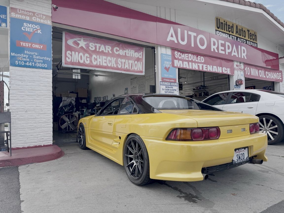 Yellow Toyota MR2 at the Union City Smog Check test bay